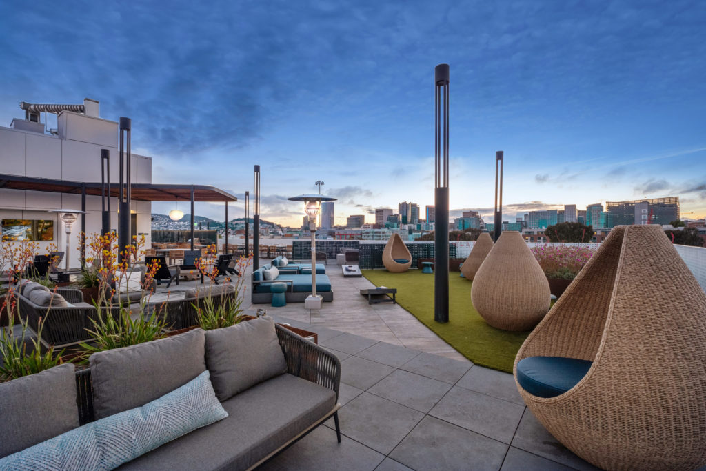Sky deck with grilling stations, TV, lounge, outdoor gaming, and views of downtown San Francisco